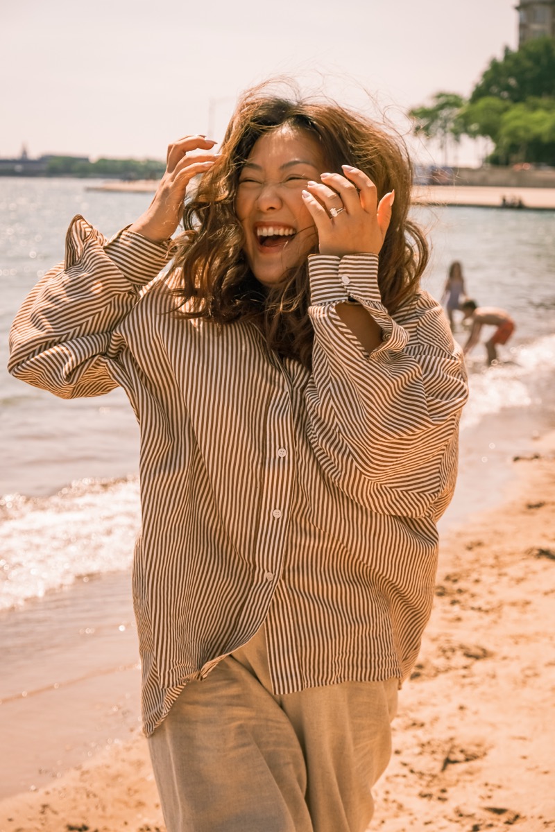 Kayla laughing at the beach
